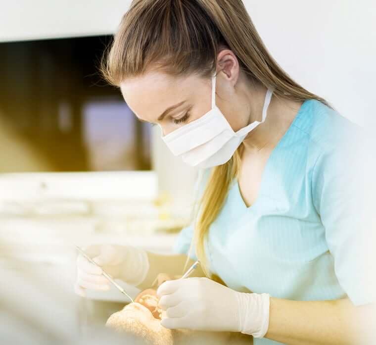 hygienist examining a patient's teeth